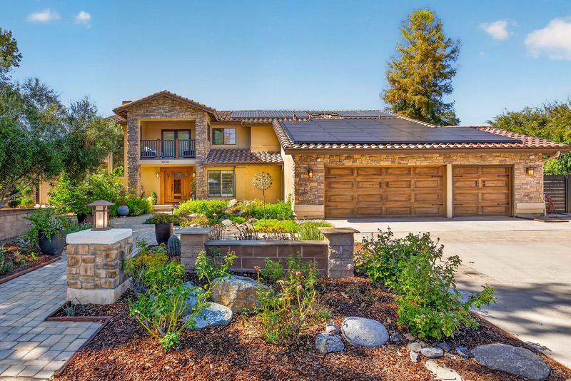 Front elevation with three car garage and drought tolerant landscaping