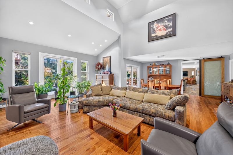 Living room with vaulted ceiling and hardwood floors