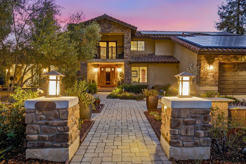 Front entry at dusk with stone pillars and lanterns
