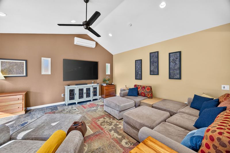 Family room with wall mounted television and mini split