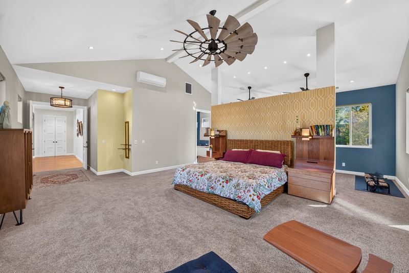 Primary bedroom with vaulted ceiling